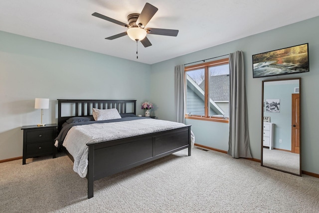 carpeted bedroom featuring baseboards and ceiling fan