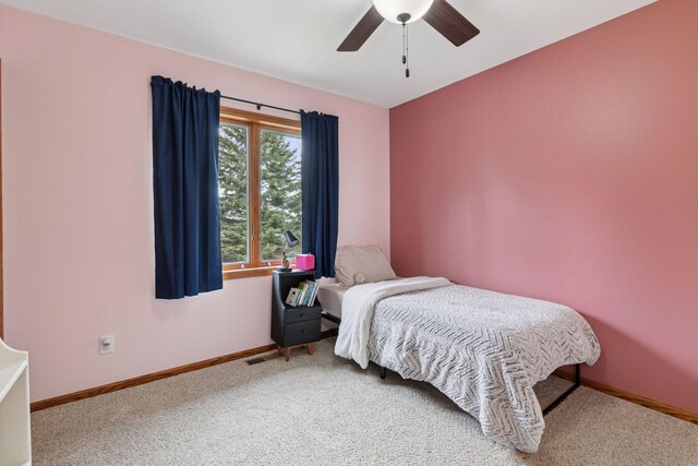 carpeted bedroom with baseboards and ceiling fan