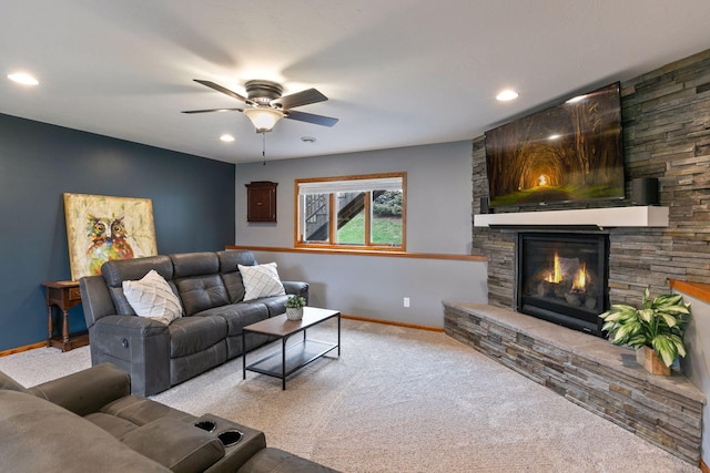 carpeted living area with ceiling fan, baseboards, a fireplace, and recessed lighting
