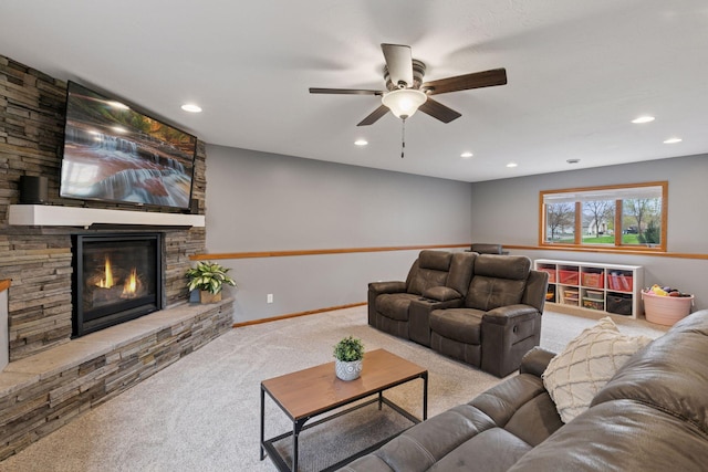living room featuring carpet, a ceiling fan, a stone fireplace, recessed lighting, and baseboards