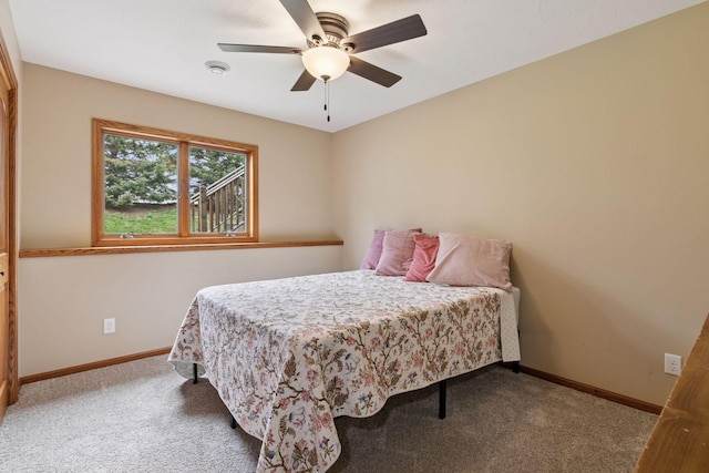 carpeted bedroom featuring baseboards and ceiling fan