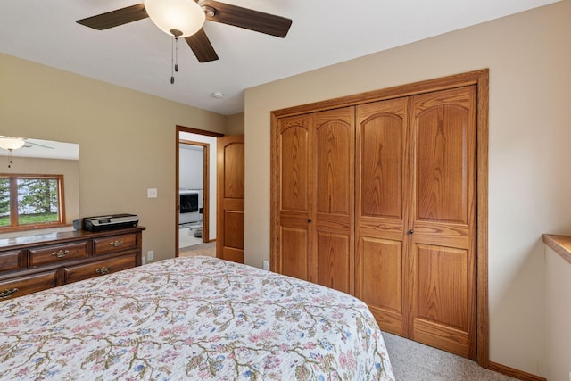 carpeted bedroom featuring a ceiling fan and a closet