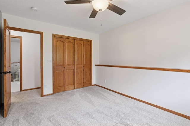 unfurnished bedroom with light carpet, baseboards, a closet, and ceiling fan