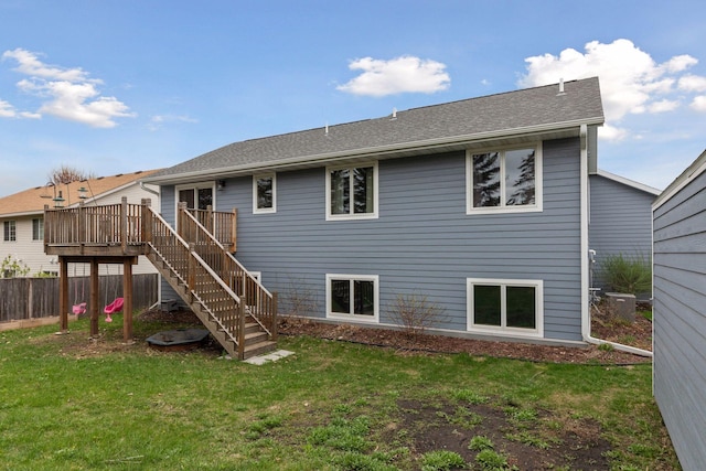 back of property featuring stairway, a wooden deck, and roof with shingles