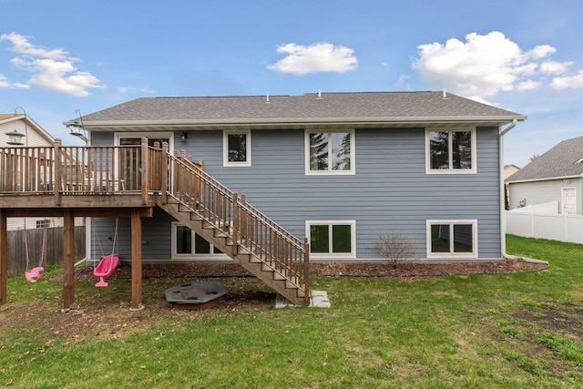 back of property featuring stairway, a wooden deck, and roof with shingles