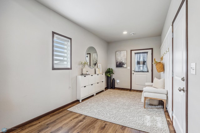 sitting room featuring a wealth of natural light, recessed lighting, baseboards, and wood finished floors