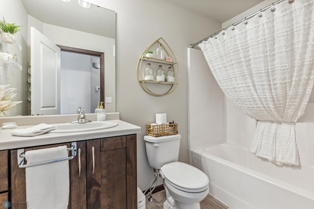 full bath with shower / tub combo, toilet, vanity, and wood finished floors