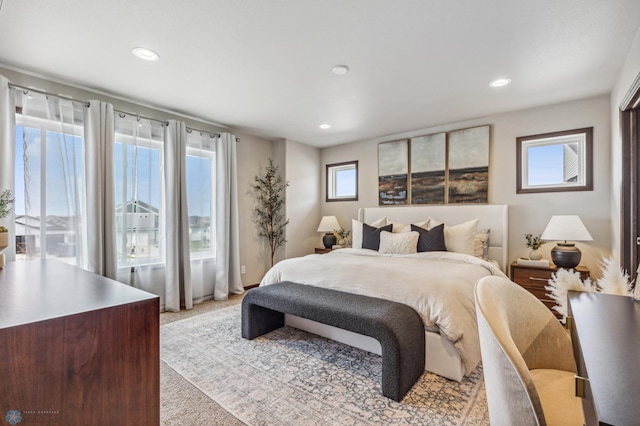 bedroom featuring light carpet and recessed lighting