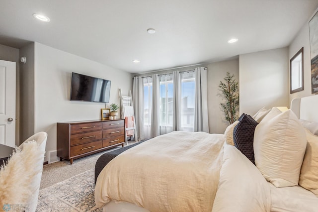 bedroom featuring visible vents, recessed lighting, and light carpet