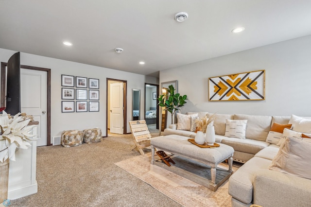 living room featuring light colored carpet, baseboards, and recessed lighting