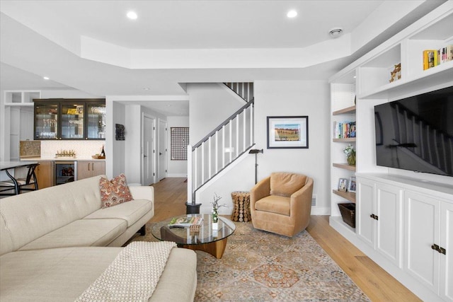 2041 Oak St, Lake City, MN 55041 - living room featuring recessed lighting, beverage cooler, a raised ceiling, light wood-type flooring, and stairs