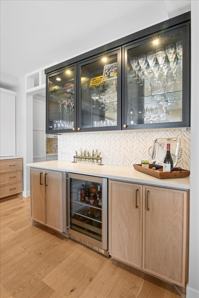 2041 Oak St, Lake City, MN 55041 - bar with backsplash, light wood-style floors, a bar, and wine cooler