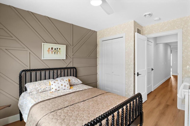 2041 Oak St, Lake City, MN 55041 - bedroom featuring a decorative wall, a ceiling fan, a closet, light wood-type flooring, and visible vents