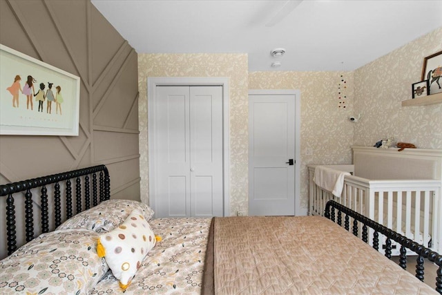 2041 Oak St, Lake City, MN 55041 - bedroom featuring wallpapered walls, a closet, and a decorative wall