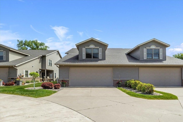 2041 Oak St, Lake City, MN 55041 - view of front facade featuring brick siding, an attached garage, concrete driveway, and a shingled roof