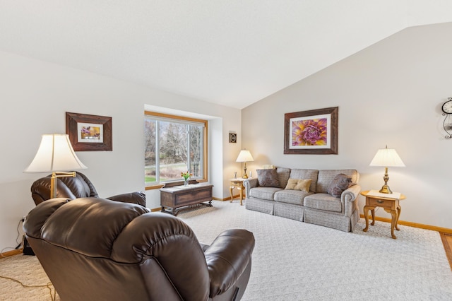 living area featuring vaulted ceiling and baseboards