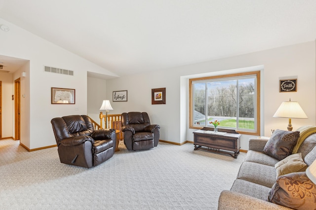 carpeted living area featuring visible vents, lofted ceiling, and baseboards