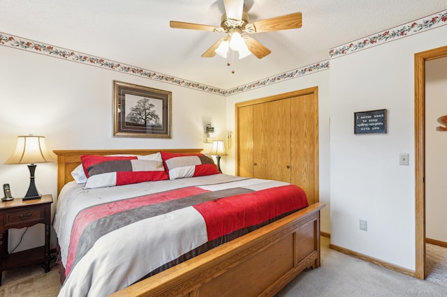 bedroom featuring a closet, baseboards, a ceiling fan, and light carpet