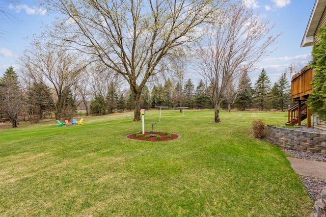 view of yard featuring a deck and stairs