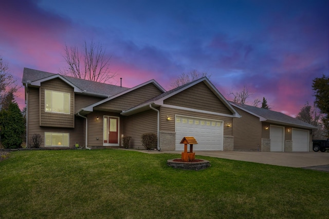 split level home with a front yard, driveway, an attached garage, and roof with shingles
