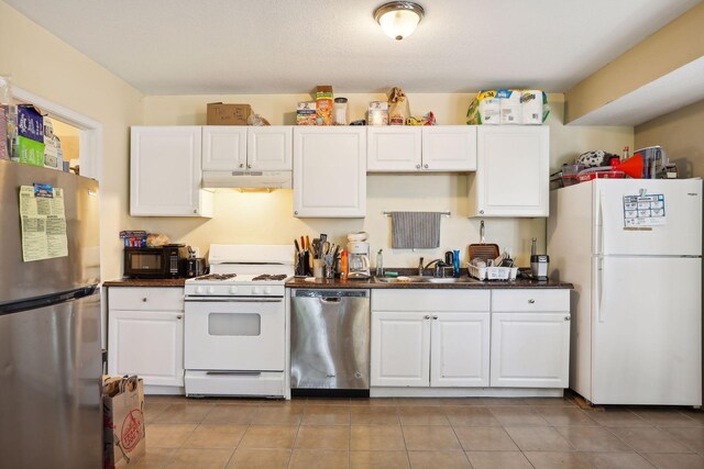 629 Oak St SE, Minneapolis, MN 55414 - kitchen featuring white cabinets, a sink, appliances with stainless steel finishes, dark countertops, and under cabinet range hood