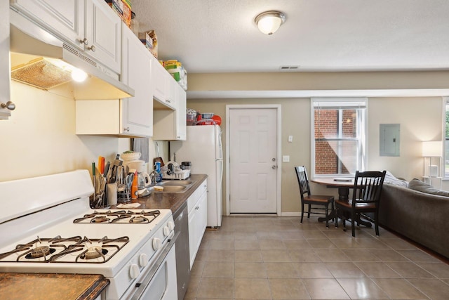 629 Oak St SE, Minneapolis, MN 55414 - kitchen featuring visible vents, light tile patterned floors, white appliances, under cabinet range hood, and white cabinetry