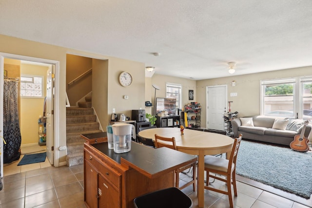 629 Oak St SE, Minneapolis, MN 55414 - kitchen featuring light tile patterned floors, ceiling fan, plenty of natural light, and a textured ceiling