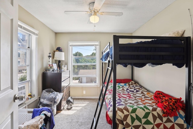 629 Oak St SE, Minneapolis, MN 55414 - bedroom with baseboards, a textured ceiling, a ceiling fan, and carpet floors