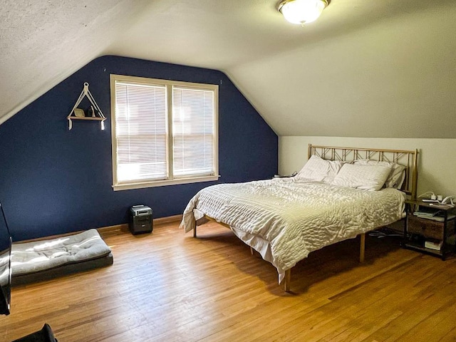 305 Kneale Ave N, Thief River Falls, MN 56701 - bedroom with baseboards, vaulted ceiling, and wood finished floors