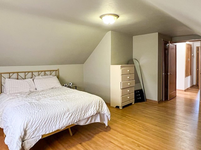 305 Kneale Ave N, Thief River Falls, MN 56701 - bedroom with light wood-type flooring and lofted ceiling