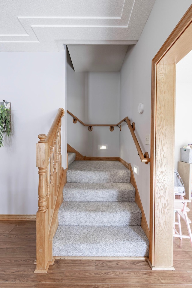 505 Welco Ln W, Montgomery, MN 56069 - staircase featuring wood finished floors and baseboards