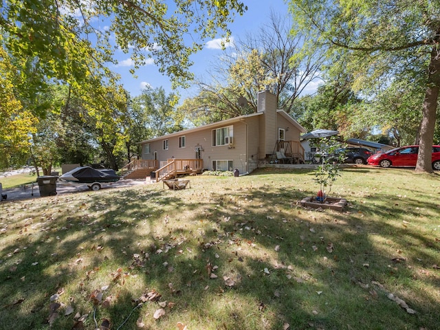 exterior space with a chimney, a wooden deck, and a front yard