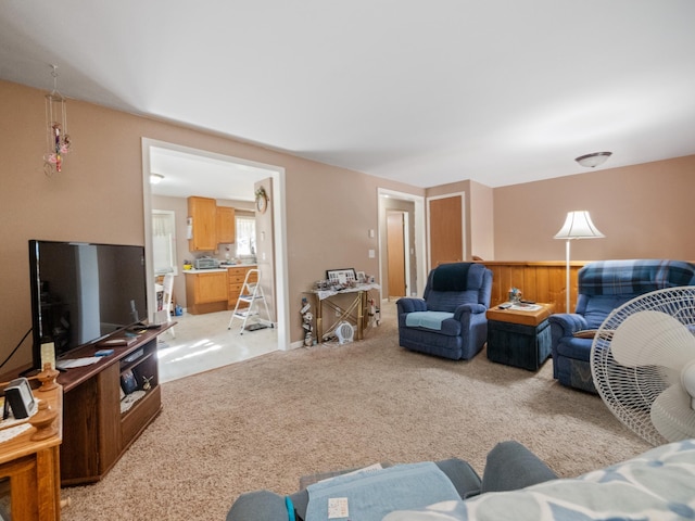 living room featuring light carpet and wainscoting