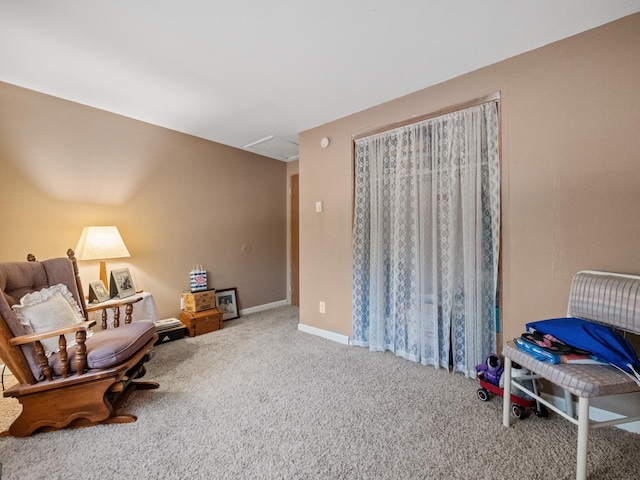 sitting room featuring carpet flooring and baseboards