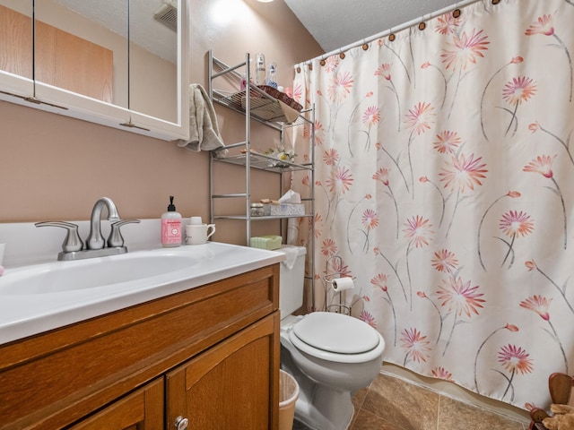 bathroom with a textured ceiling, vanity, tile patterned flooring, toilet, and a shower with shower curtain
