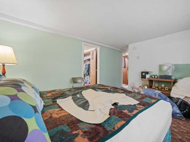 bedroom featuring a walk in closet and a closet