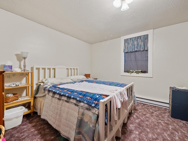 carpeted bedroom with baseboard heating and a textured ceiling