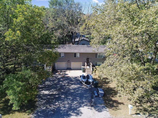 view of front facade with aphalt driveway and a garage