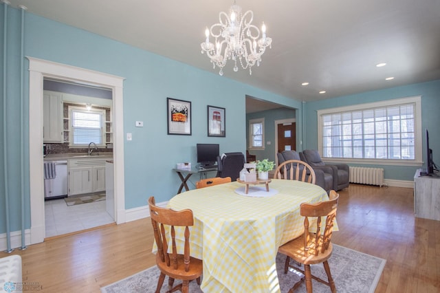 708 1st St N, Fargo, ND 58102 - dining area featuring light wood-style floors, radiator, and baseboards