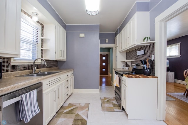 708 1st St N, Fargo, ND 58102 - kitchen featuring open shelves, a sink, decorative backsplash, and stainless steel appliances