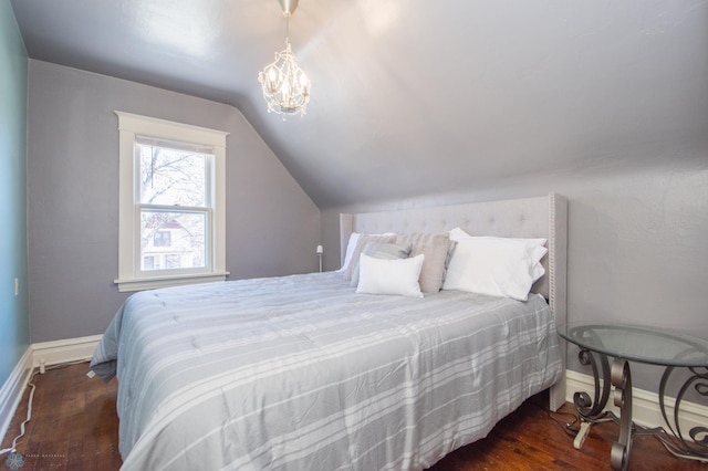 708 1st St N, Fargo, ND 58102 - bedroom with an inviting chandelier, baseboards, vaulted ceiling, and hardwood / wood-style flooring