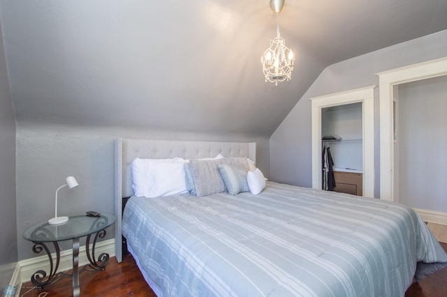708 1st St N, Fargo, ND 58102 - bedroom featuring vaulted ceiling, wood finished floors, baseboards, a closet, and a chandelier