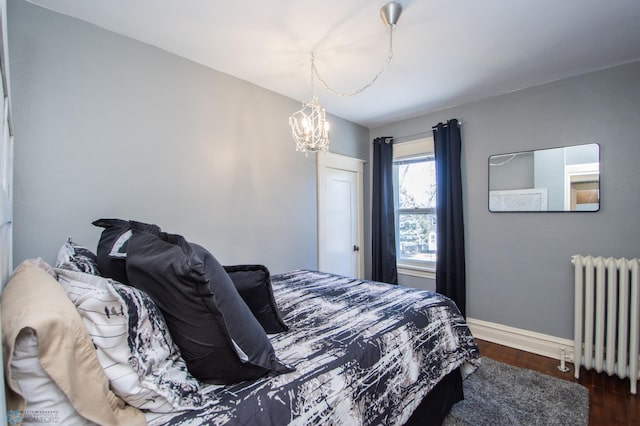 708 1st St N, Fargo, ND 58102 - bedroom featuring an inviting chandelier, radiator, dark wood-style flooring, and baseboards