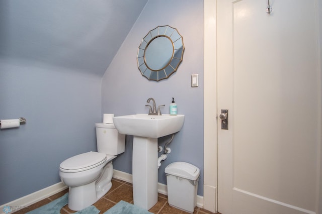 708 1st St N, Fargo, ND 58102 - half bathroom featuring baseboards, tile patterned flooring, toilet, and lofted ceiling