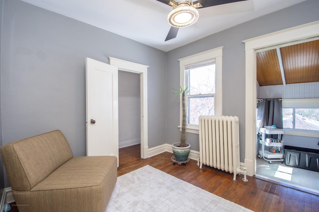 708 1st St N, Fargo, ND 58102 - living area featuring wood finished floors, a ceiling fan, baseboards, and radiator heating unit
