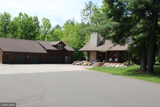 14638 State Highway 70, Pine City, MN 55063 - view of front facade featuring a chimney and a garage