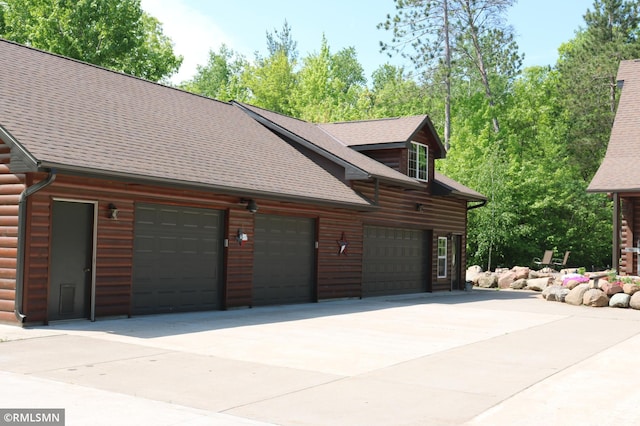 14638 State Highway 70, Pine City, MN 55063 - view of side of property featuring faux log siding, roof with shingles, and driveway