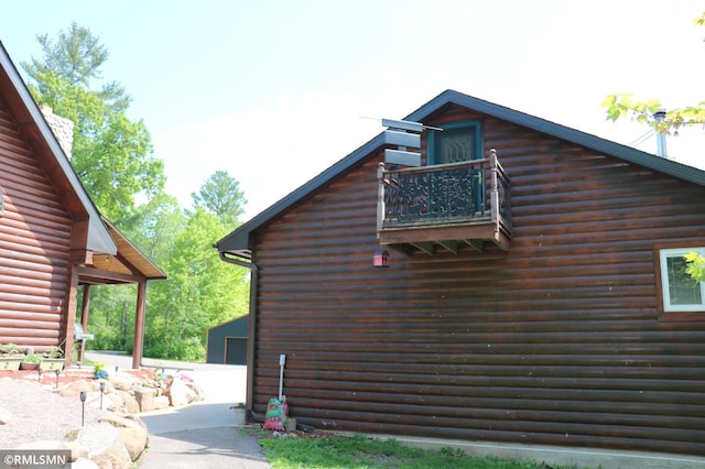 14638 State Highway 70, Pine City, MN 55063 - view of property exterior with a balcony and faux log siding