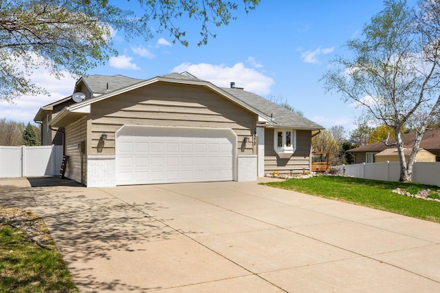 ranch-style home featuring brick siding, an attached garage, fence, and driveway