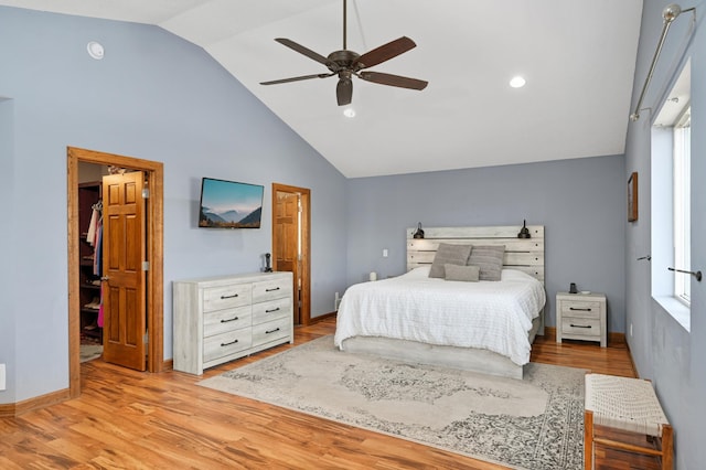 bedroom with ceiling fan, baseboards, high vaulted ceiling, and light wood-style floors